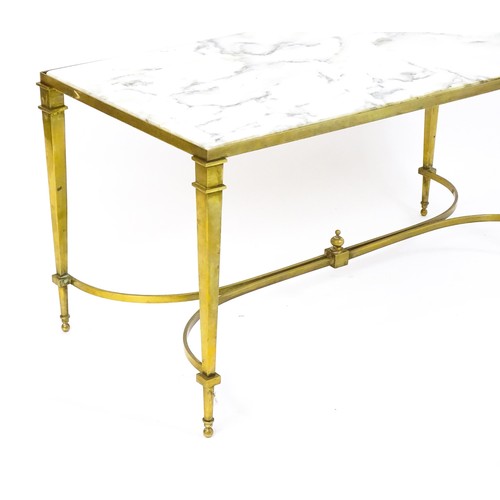 1721 - A late 19thC / early 20thC marble topped coffee table with a brass base and four tapering legs unite... 