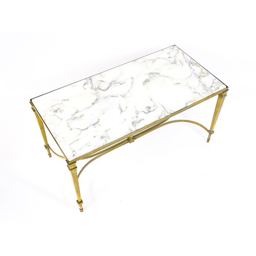 1721 - A late 19thC / early 20thC marble topped coffee table with a brass base and four tapering legs unite... 