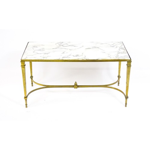 1721 - A late 19thC / early 20thC marble topped coffee table with a brass base and four tapering legs unite... 