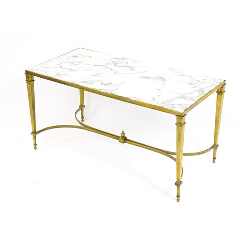 1721 - A late 19thC / early 20thC marble topped coffee table with a brass base and four tapering legs unite... 