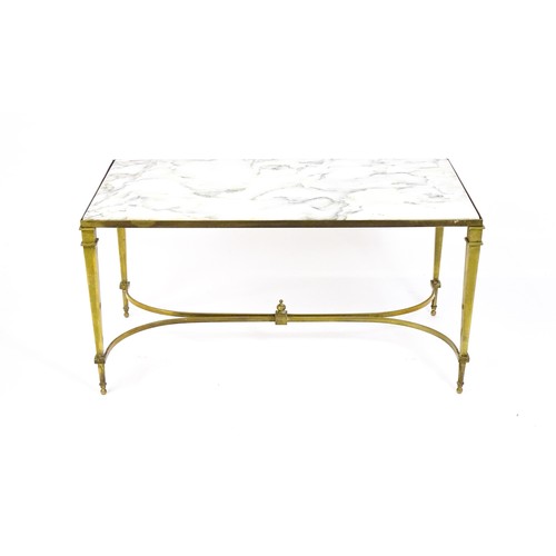 1721 - A late 19thC / early 20thC marble topped coffee table with a brass base and four tapering legs unite... 