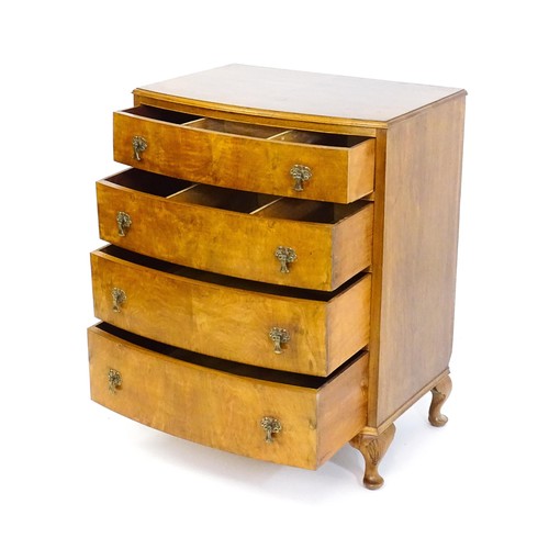 1733 - An Art Deco style walnut chest of drawers with a bowed front and four long drawers raised on four ca... 