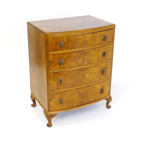 1733 - An Art Deco style walnut chest of drawers with a bowed front and four long drawers raised on four ca... 