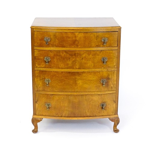 1733 - An Art Deco style walnut chest of drawers with a bowed front and four long drawers raised on four ca... 