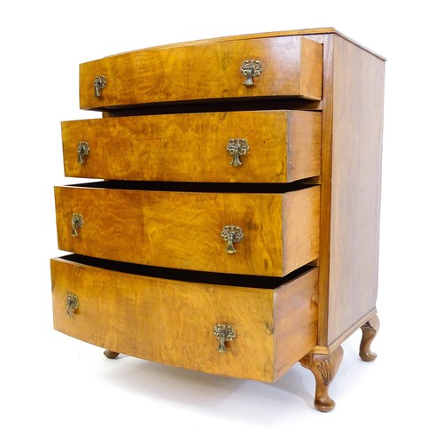 1733 - An Art Deco style walnut chest of drawers with a bowed front and four long drawers raised on four ca... 