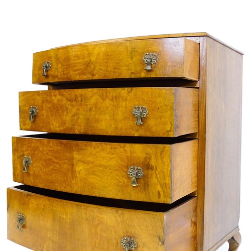 1733 - An Art Deco style walnut chest of drawers with a bowed front and four long drawers raised on four ca... 