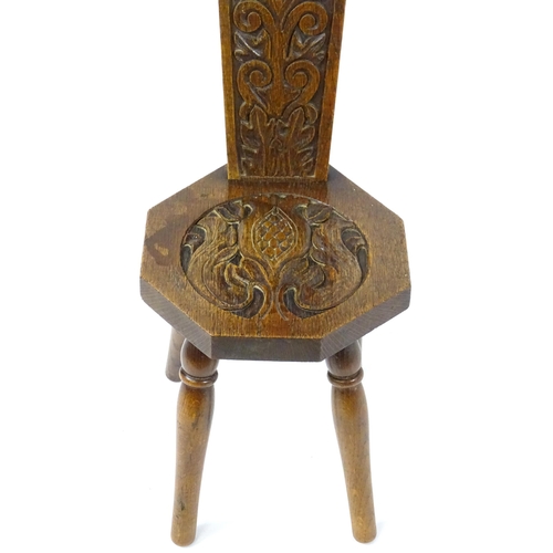 1738 - Local interest: Winslow, Buckinghamshire - An early / mid 20thC oak spinners chair with a carved bac... 