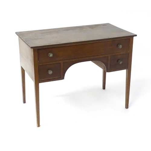 1744 - An early 19thC mahogany desk / sideboard, with a rectangular top above a fitted long drawer and two ... 