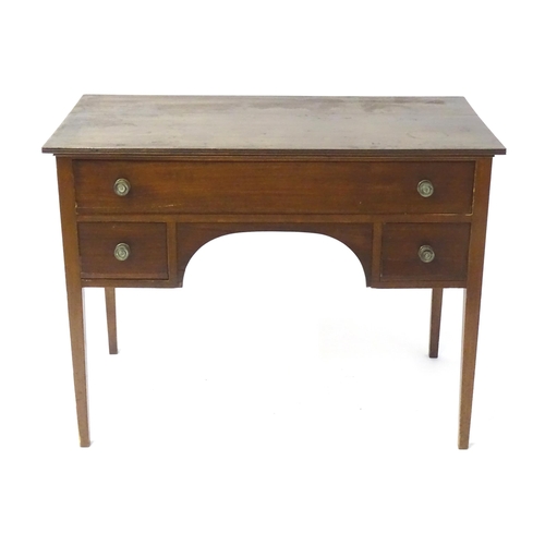 1744 - An early 19thC mahogany desk / sideboard, with a rectangular top above a fitted long drawer and two ... 