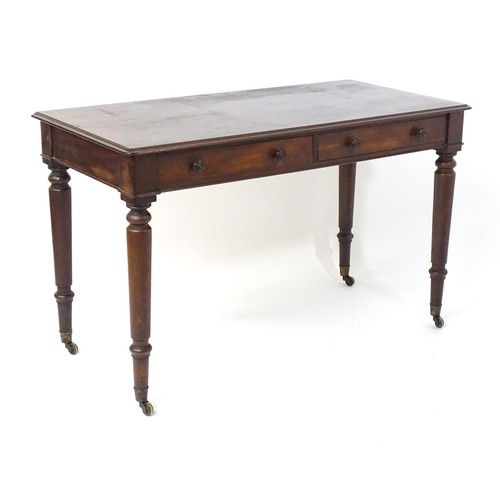 1747 - An early 19thC mahogany two drawer writing desk, having a moulded top above two short drawers with t... 