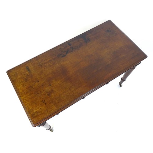 1747 - An early 19thC mahogany two drawer writing desk, having a moulded top above two short drawers with t... 