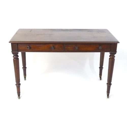 1747 - An early 19thC mahogany two drawer writing desk, having a moulded top above two short drawers with t... 