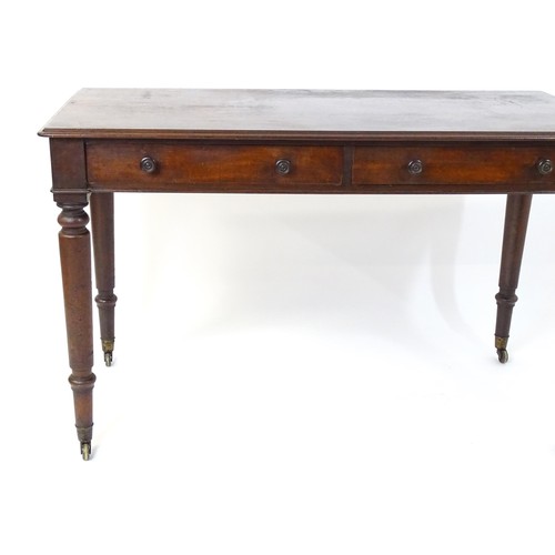 1747 - An early 19thC mahogany two drawer writing desk, having a moulded top above two short drawers with t... 