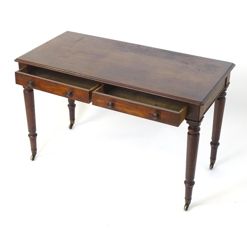 1747 - An early 19thC mahogany two drawer writing desk, having a moulded top above two short drawers with t... 