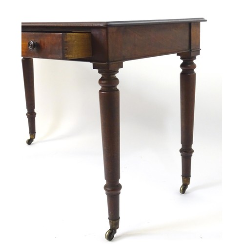 1747 - An early 19thC mahogany two drawer writing desk, having a moulded top above two short drawers with t... 