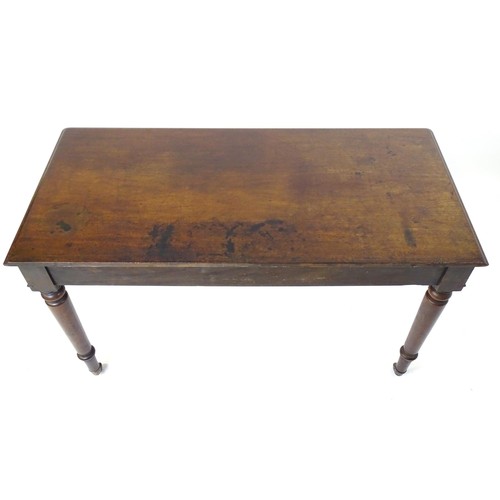 1747 - An early 19thC mahogany two drawer writing desk, having a moulded top above two short drawers with t... 