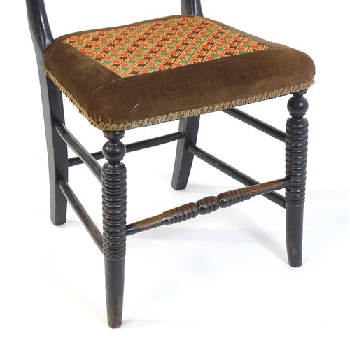 1748 - A 19thC ebonised side chair, having a bowed top rail above a turned mid rail and bobbin turned style... 