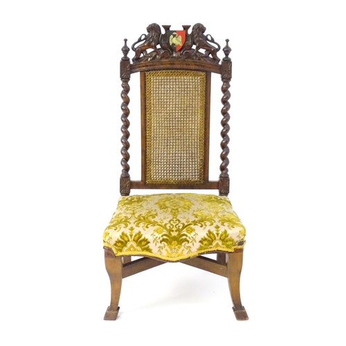 1751 - A late 19thC carved chair with a caned backrest and applied Buckinghamshire armorial shield flanked ... 