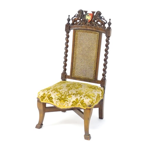 1751 - A late 19thC carved chair with a caned backrest and applied Buckinghamshire armorial shield flanked ... 