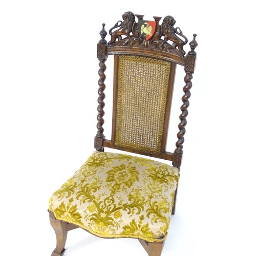 1751 - A late 19thC carved chair with a caned backrest and applied Buckinghamshire armorial shield flanked ... 