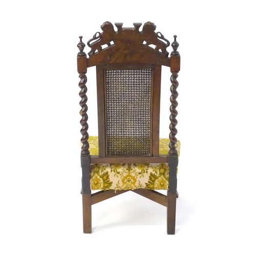 1751 - A late 19thC carved chair with a caned backrest and applied Buckinghamshire armorial shield flanked ... 