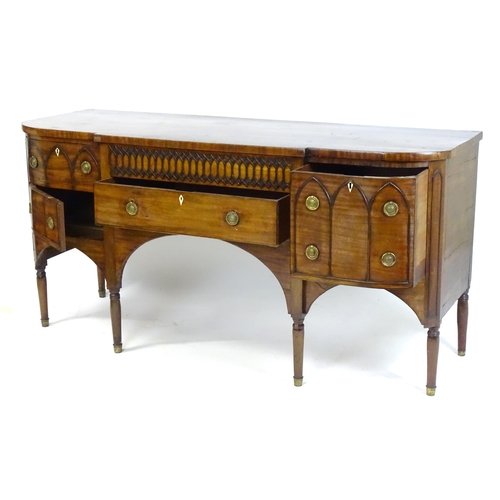 1752 - An early / mid 19thC mahogany Gothic sideboard, having a D-shaped top above lancet mouldings and rin... 