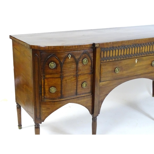 1752 - An early / mid 19thC mahogany Gothic sideboard, having a D-shaped top above lancet mouldings and rin... 