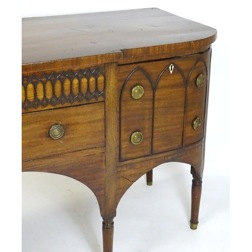 1752 - An early / mid 19thC mahogany Gothic sideboard, having a D-shaped top above lancet mouldings and rin... 