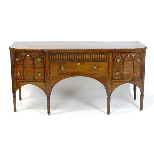 1752 - An early / mid 19thC mahogany Gothic sideboard, having a D-shaped top above lancet mouldings and rin... 