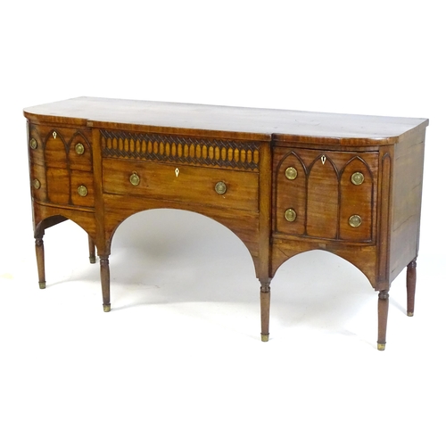 1752 - An early / mid 19thC mahogany Gothic sideboard, having a D-shaped top above lancet mouldings and rin... 