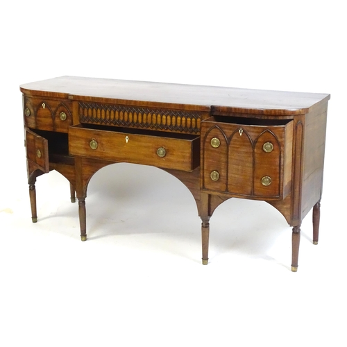 1752 - An early / mid 19thC mahogany Gothic sideboard, having a D-shaped top above lancet mouldings and rin... 