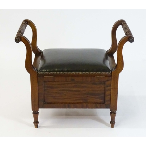 1753 - An early / mid 19thC mahogany piano stool / window seat with a lifting leather upholstered seat flan... 