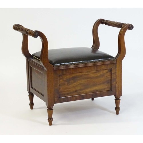 1753 - An early / mid 19thC mahogany piano stool / window seat with a lifting leather upholstered seat flan... 