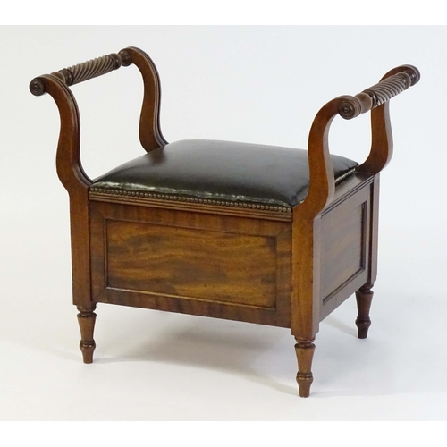 1753 - An early / mid 19thC mahogany piano stool / window seat with a lifting leather upholstered seat flan... 