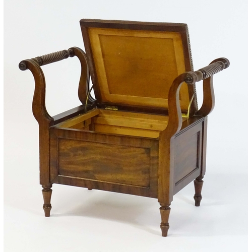 1753 - An early / mid 19thC mahogany piano stool / window seat with a lifting leather upholstered seat flan... 