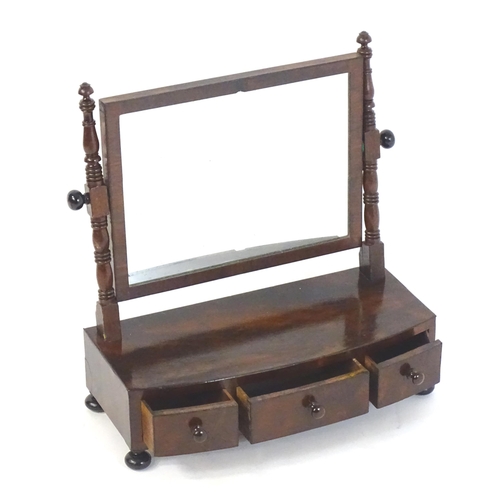 1755 - An early 19thC mahogany toilet mirror, having turned uprights and a rectangular mirror to the centre... 