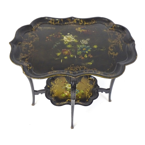 1762 - A 19thC ebonised table with two papier machete tiers. both tiers formed from tray tops and having ha... 