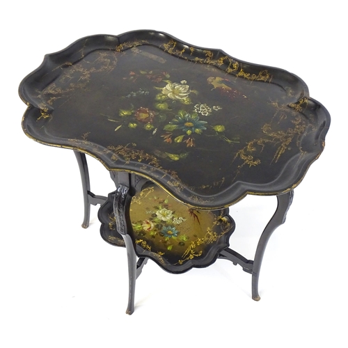 1762 - A 19thC ebonised table with two papier machete tiers. both tiers formed from tray tops and having ha... 