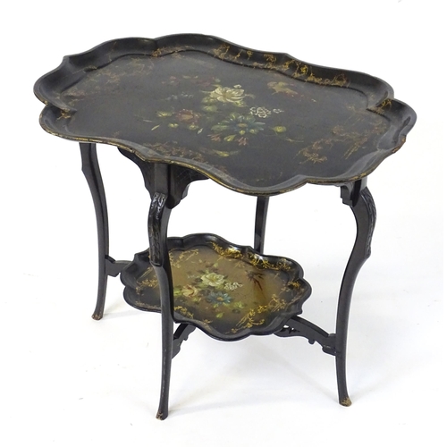 1762 - A 19thC ebonised table with two papier machete tiers. both tiers formed from tray tops and having ha... 