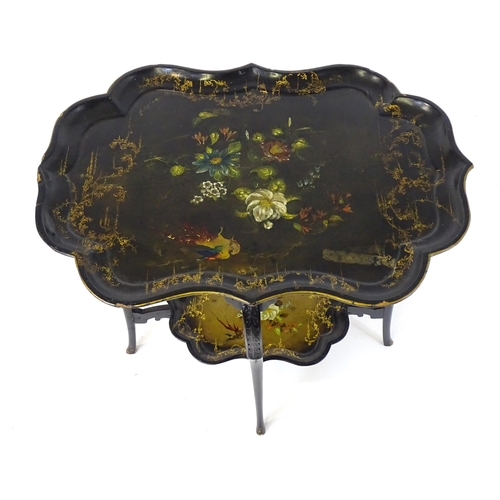 1762 - A 19thC ebonised table with two papier machete tiers. both tiers formed from tray tops and having ha... 