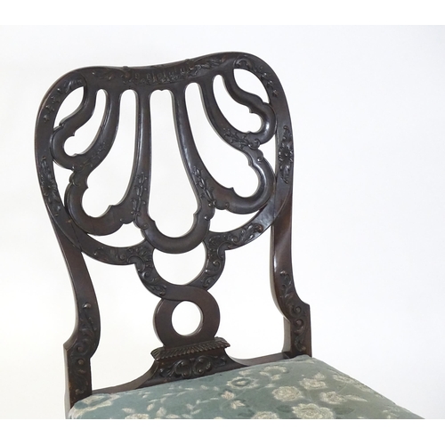 1763 - A Victorian mahogany Chippendale style side chair, having a carved, pierced backrest and raised on c... 