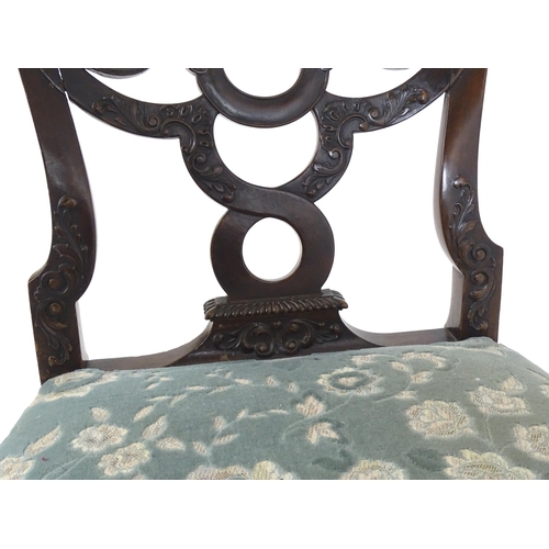 1763 - A Victorian mahogany Chippendale style side chair, having a carved, pierced backrest and raised on c... 