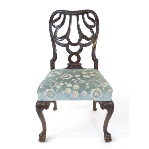 1763 - A Victorian mahogany Chippendale style side chair, having a carved, pierced backrest and raised on c... 