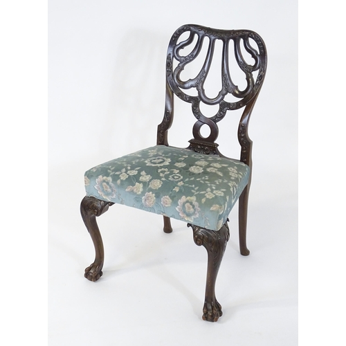 1763 - A Victorian mahogany Chippendale style side chair, having a carved, pierced backrest and raised on c... 