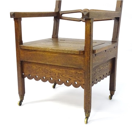 1765 - An Arts and Crafts style oak chair, having a pierced pointed top rail and shaped mid rail above a hi... 