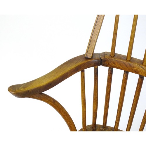 1767 - An early / mid 19thC Windsor chair of ash, elm and beech construction, having a double bow back, swe... 