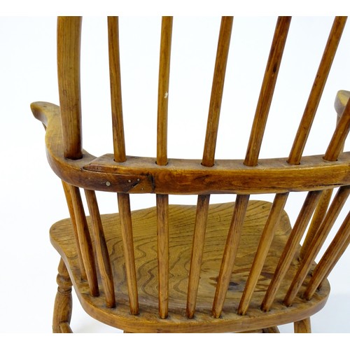 1767 - An early / mid 19thC Windsor chair of ash, elm and beech construction, having a double bow back, swe... 