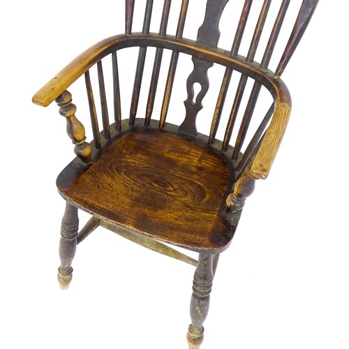 1768 - A mid 19thC ash and elm double bow back Windsor armchair, having a central pierced back splat above ... 