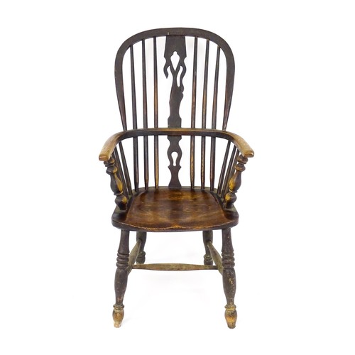 1768 - A mid 19thC ash and elm double bow back Windsor armchair, having a central pierced back splat above ... 