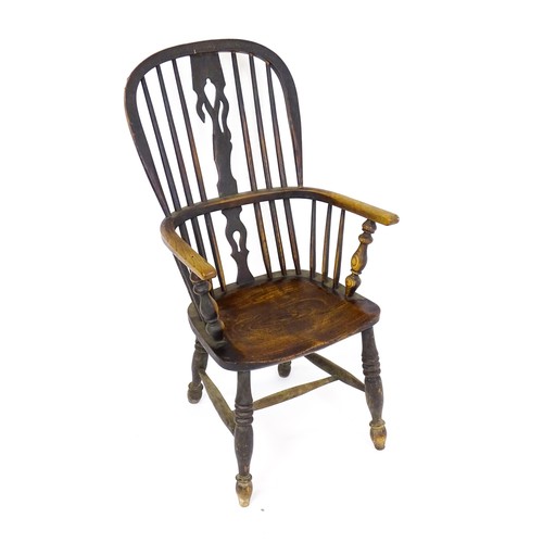 1768 - A mid 19thC ash and elm double bow back Windsor armchair, having a central pierced back splat above ... 